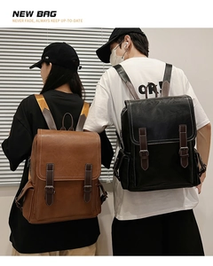 Detail of vintage leather backpacks in black and brown with double buckle flap design