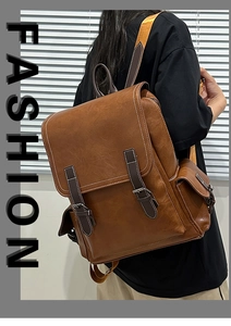 Close-up of vintage brown PU leather backpack with buckle straps and side pocket