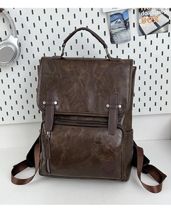 Detail view of vintage dark brown PU leather backpack with buckle straps and side pocket