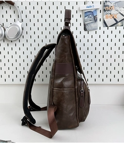 Side view of dark brown PU leather backpack showing large capacity and mesh shoulder straps