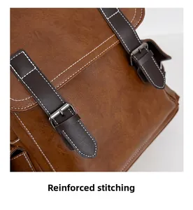 Macro shot of reinforced white contrast stitching on vintage brown leather backpack
