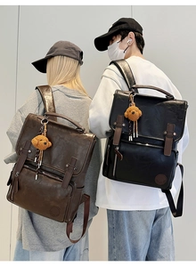 Street style shot of brown and black PU leather backpacks with plush charm and buckles