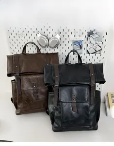 Detailed view of vintage PU leather backpacks with metal buckles in brown and black
