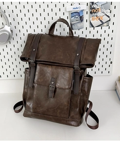 Detail view of vintage dark brown PU leather backpack with dual buckle straps and side pockets