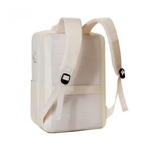 Detail of ergonomic padded shoulder straps and breathable mesh back panel on beige backpack