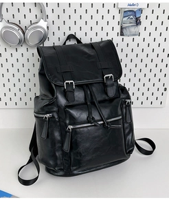 Close-up of black PU leather backpack with magnetic buckles and drawstring closure