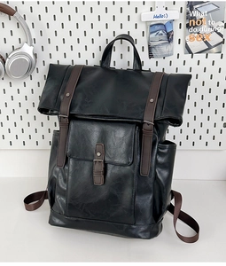 Detail view of vintage black PU leather backpack with brown straps and buckle closure