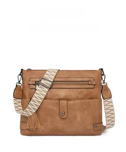 Brown vintage crossbody bag with fringe detail and geometric pattern wide strap