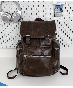 Detailed view of deep brown PU leather backpack with buckle straps and drawstring closure