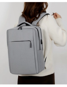 Detail of grey business laptop backpack featuring ergonomic padded straps and USB port
