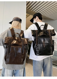 Detailed view of vintage PU leather backpacks in brown and black on models