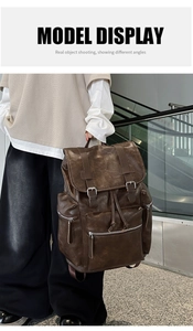 Brown vintage faux leather backpack with flap cover and buckle detail worn by a model
