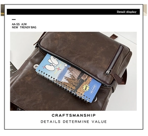 Detail of vintage PU leather backpack front zip pocket with notebook showing storage space