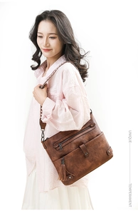 Brown vintage washed leather shoulder bag with fringe detail and woven floral strap
