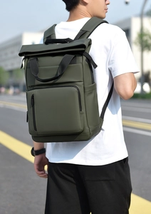 Deep olive green waterproof commuter backpack with roll-top closure and matte finish