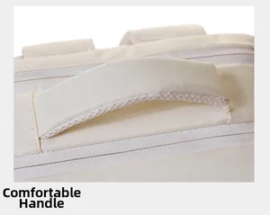Close-up of padded handle and smooth zippers on a durable beige minimalist backpack