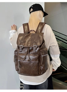 Detail of vintage dark brown large capacity backpack with premium texture and buckle straps