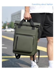 Detail of army green waterproof roll-top backpack with front zipper pocket and side pockets