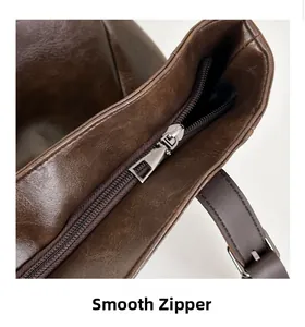 Detail of smooth metal zipper and premium stitching on retro brown faux leather backpack