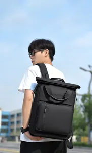 Waterproof business travel backpack with expandable top design worn by male model outdoors