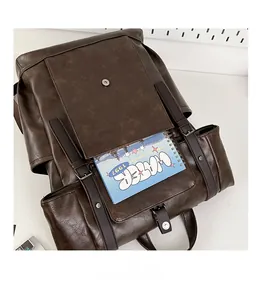 Detail view of front pocket capacity in vintage brown PU leather travel backpack