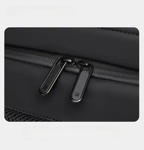 Detail of durable dual matte black metal zippers on waterproof black fabric business backpack