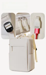 Detail of backpack showing USB charging port, smooth metal zippers and padded shoulder straps