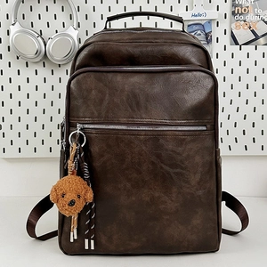 Retro dark brown leather backpack with multiple pockets and cute teddy bear charm