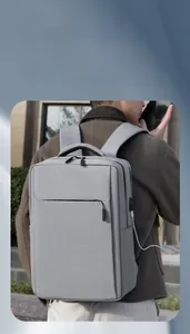 Detail of the built-in USB charging port and water-resistant fabric on gray business backpack