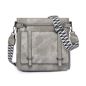 Detailed view of gray messenger bag with vintage texture and geometric wide strap