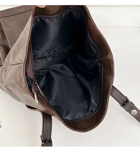Internal view of the brown leather backpack with black lining and secure zipper pocket