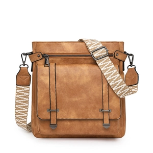Detail of caramel leather shoulder bag showing the textured finish and buckle flip cover