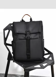 Detail of waterproof black tactical backpack with functional buckle and orange trim accents
