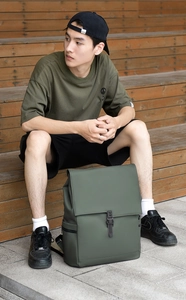 Army green waterproof commuter backpack featuring a secure buckle closure and side zipper
