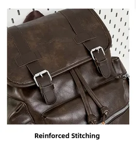 Close-up of reinforced stitching and metal buckle on dark brown vintage backpack