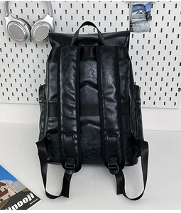 Detail of the black PU leather backpack with padded straps and luggage trolley sleeve