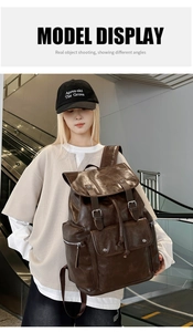 Deep brown vintage PU leather backpack with double buckle and drawstring shown on model