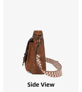 Side view of brown faux leather bucket bag with geometric patterned wide shoulder strap