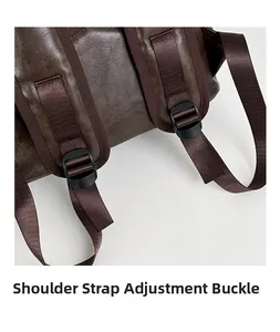 Detail of adjustable strap buckle on vintage brown leather backpack with nylon webbing