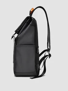 Side view of roll-top black backpack with breathable mesh back and orange accents
