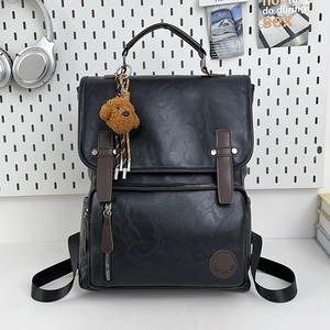 Retro black PU leather backpack with brown accents and teddy bear pendant