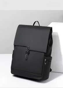 Detail of minimalist black business backpack featuring flap cover and durable plastic buckle