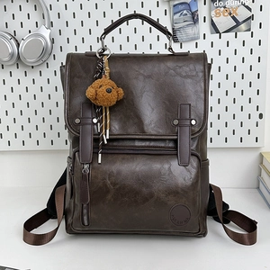 Retro deep brown PU leather backpack with plush pendant and adjustable straps