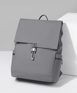 Detail view of grey waterproof backpack showing buckle closure and reinforced stitching