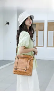 Brown vintage PU leather crossbody bucket bag with multi-pockets shown on model