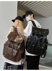 Detailed view of coffee brown and black vintage PU leather backpacks with buckles