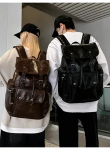 Front view of vintage PU leather backpacks in brown and black with buckle closure