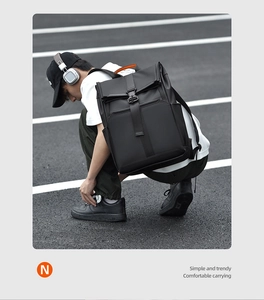 Close-up of black water-resistant roll-top backpack with secure buckle and side pockets
