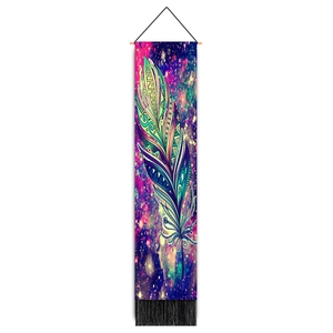 Detailed close-up of bohemian tapestry with colorful feather design and black tassels