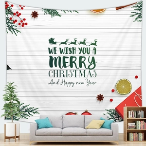 Close-up of a Christmas tapestry with Santa's sleigh and reindeer on a white wood backdrop